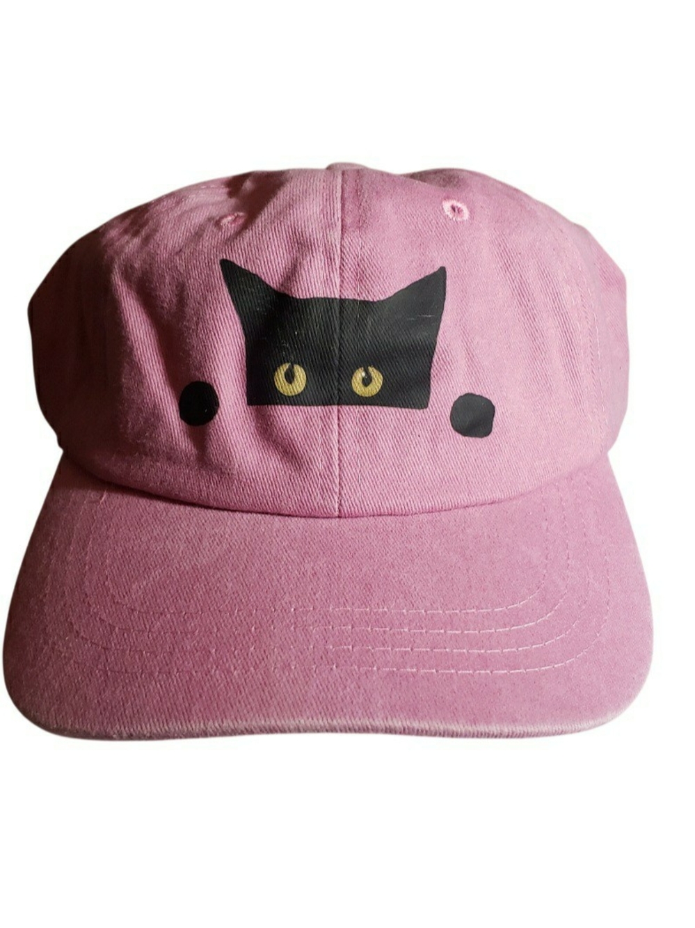 Pink cotton hat featuring a peeking black cat design with yellow eyes.